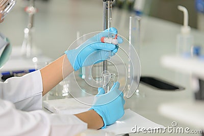 The woman whoâ€™s the scientist is demonstrate the titration technique Stock Photo